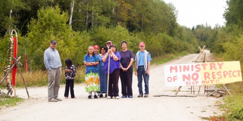 Andrew (Shoon) Keewatin, Jr., left, stands by the 12-year Grassy Narrows blockad