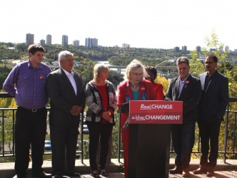 Standing with Liberal Aboriginal affairs critic Dr. Carolyn Bennett (behind podi
