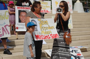 Jason Jr. stands with his grandmother Evelyn Simpson and rally co-organizer Apr