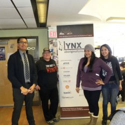 LYNX marketing assistant Kendall Yellowhorn (from left) visits with students 
