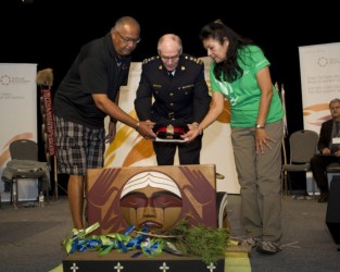 Saskatoon Police Service Chief Clive Weighill (centre) places a hat in the Bentw