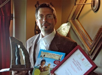 Victor Lethbridge holds both his award and his award-winning book, Little Chief 