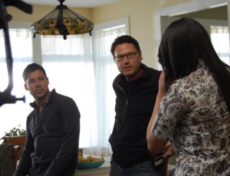 Director Ron E. Scott (centre) discusses a scene just shot with actors Justin Ra