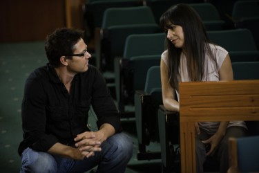 Director Ron E. Scott talk to actor Carmen Moore during production.