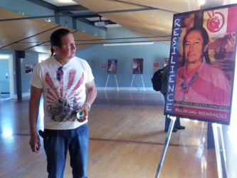 Artist Philip Cote with poster of Russell Means
