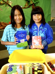 Students Rain Goodstoney (left) and Serenity Fox help with the packaging of card