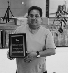 Andrew Mixemong holds the “model centre” award his Georgian Bay Friendship Centr