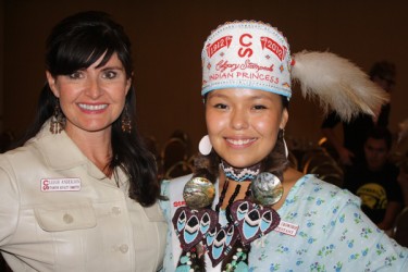 Leigh Anderson, of the Stampede Royalty Committee, congratulates Amelia Crowshoe