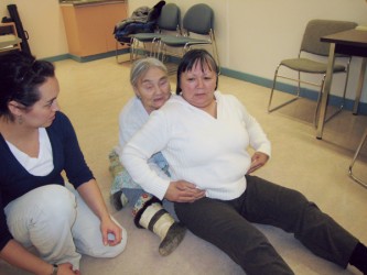 Traditional midwife Qapik Attaqutsiak (Arctic Bay) demonstrates midwifery positi