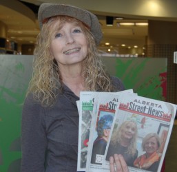 Linda Dumont displays copies of Alberta Street News