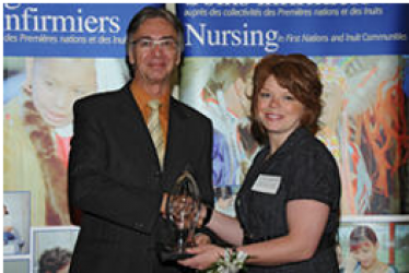 MP Tony Clement congratulates Tracy Daigneault for her award which she received 