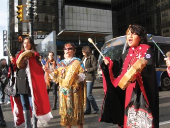 Drumming and singing filled the intersection of Georgia and Granville streets bl