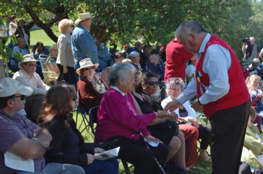 Saddle Lake First Nation coordinator Charles Wood presents Florence Large with a