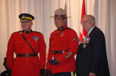 Corporal Mel Calahasen (center)