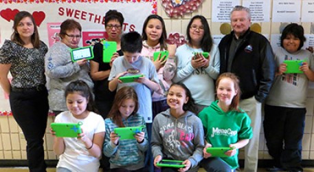 Wabowden Mayor Reginald Mead (right) attends the One Laptop per Child Canada