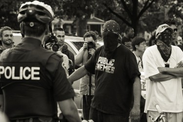 Harrison Friesen (in the Public Enemies T-shirt) engages Toronto police officers