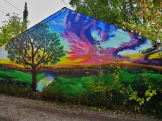 The mural painted by Jesse Black Plume acts as a backdrop for an animated film p