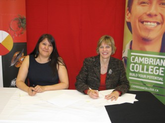 Apitisawin Pres Mary Jane Archibald (left) Cambrian College Pres S