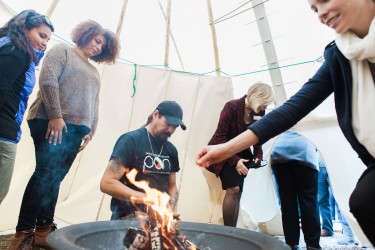 A sage and tobacco ceremony inside its newly installed tipi