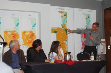 Dr. Petr Komers points out an area of interest on the Lower Athabasca Regional P