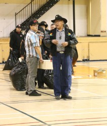 Remains are brought into gymnasium lead by Leonard Sdaddleback