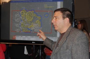 Reg Letourneau, president of Anvil GeoSpatial Corporation, shows map