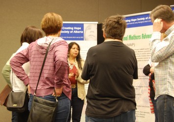 Bernadette Iahtail talks to a group of people about the Creating Hope Society’s 