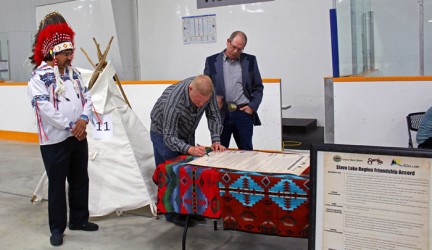 Sawridge Chief Roland Twinn and MD of Slave River Reeve Murray Kerik watch as Sl