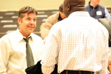 Darryl Bereziuk discusses his presentation with an interested student.