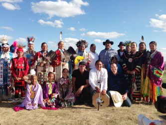Sean Hogan (last from right front row) creates a music video at Siksika with dru