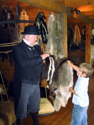 In a demonstration of how furs were historically traded, an actor portrays John 