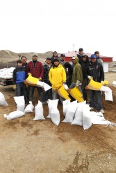 Workers making sandbags to protect from flooding.