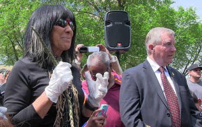 Buffy Sainte-Marie prepares to put her hands in cement