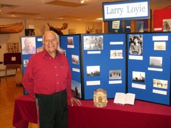 Larry Loyie in front of the permanent residential school display 