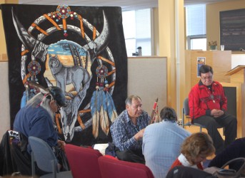 Elders Jerry Wood (seated in chair) and Leonard Saddleback preside over a ceremo