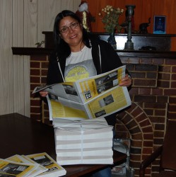 Calgary writer and vendor Andie WL holds Alberta Street News