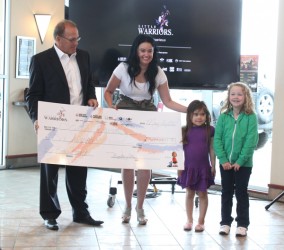 Bart Yachimec and Glori Meldrum display the $600,000 cheque from the Yachimec Au
