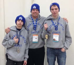 Cody Gauthier (left),  coach Kris Hansen, and Wyatt Brill (right)
