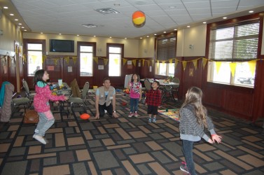 Save the Children staff member Yannis Koumarianos plays with some children