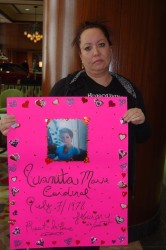Danielle Boudreau with a poster of her sister Juanita Cardinal